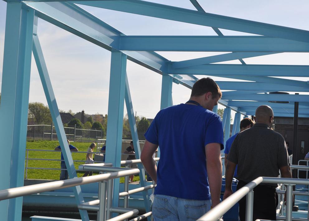 people walking into the water plant