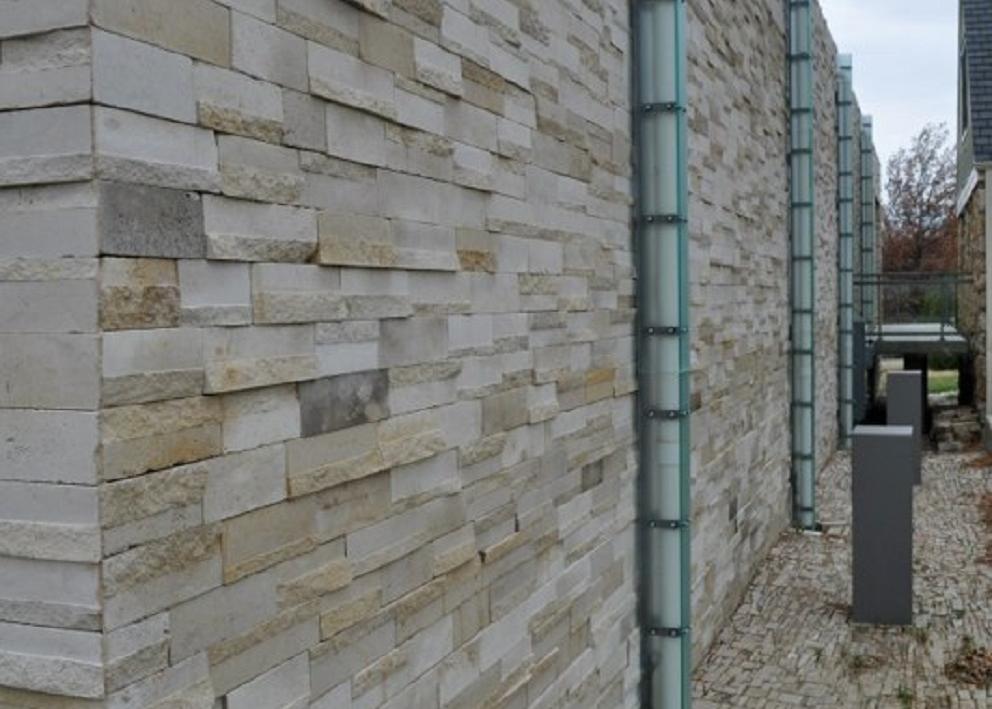 View of the wall outside with pipes coming out of the ground