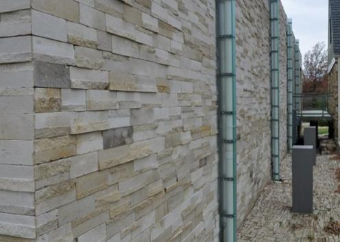 View of the wall outside with pipes coming out of the ground